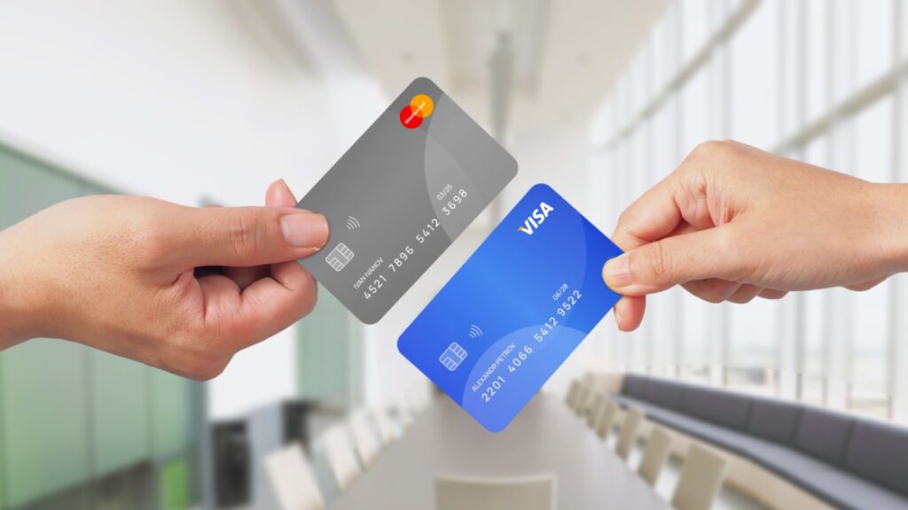 Руки тримають картки Visa і Mastercard