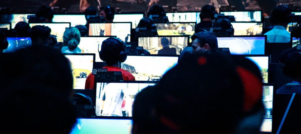 Багато людей працюють за комп'ютерами в одній кімнаті