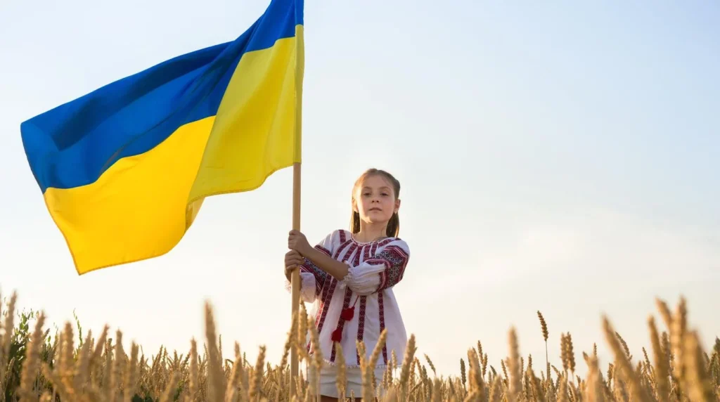 фото дитини у вишиванці, яка несе прапор України 